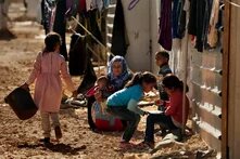 A woman sits with children at Jordan’s Zaatari refugee camp, back in 2016